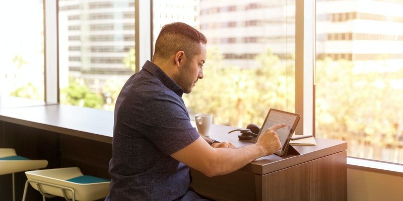 man-sitting-in-front-of-his-laptop-1251845