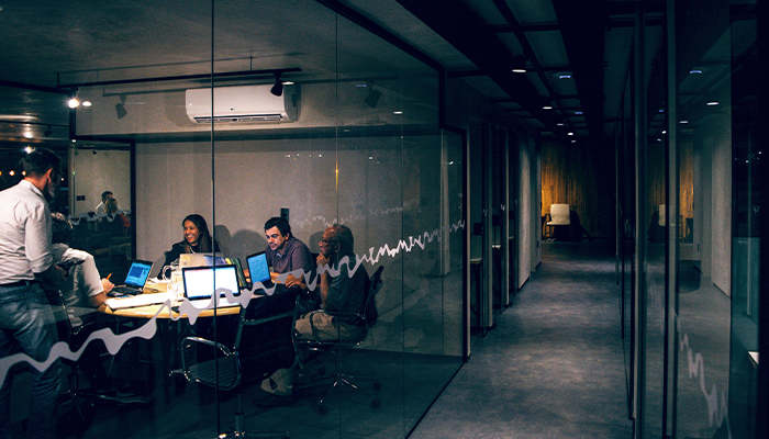 team working late in an office with laptops