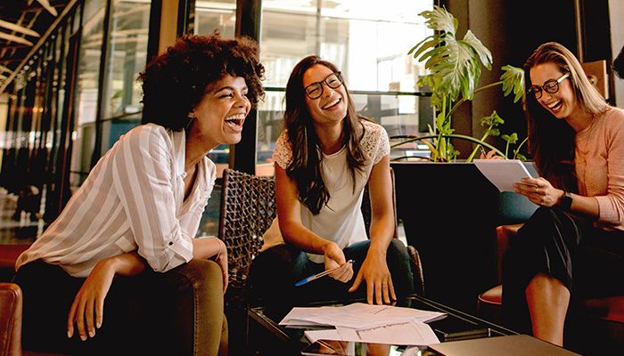 women sitting and laughing