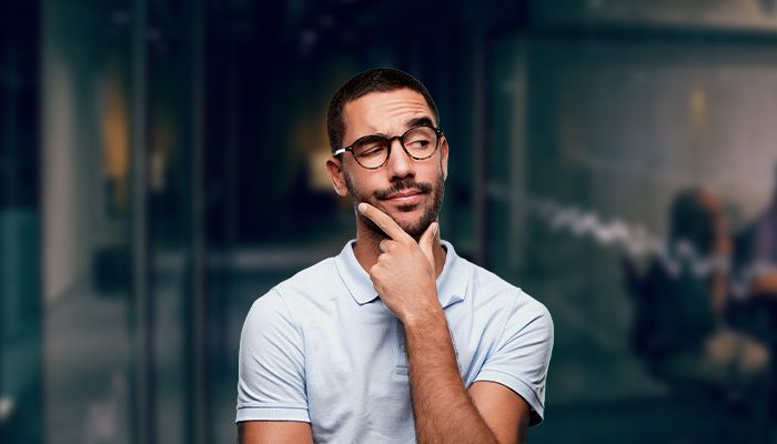 man with glasses thinking